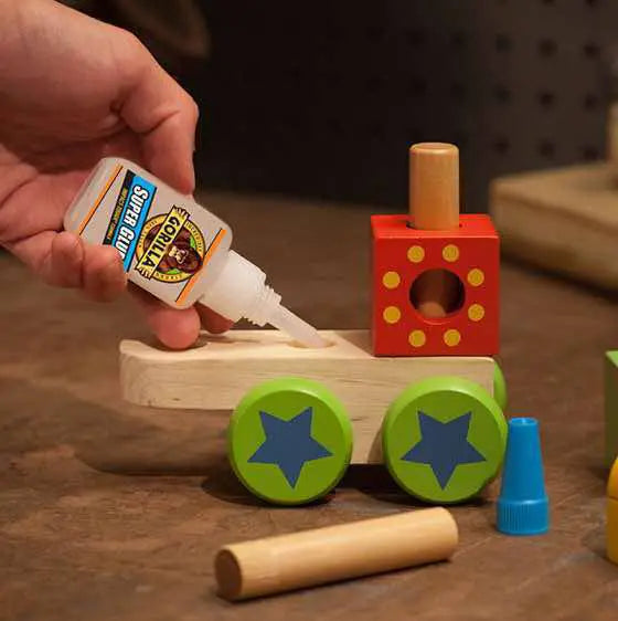 super glue being used to glue toy